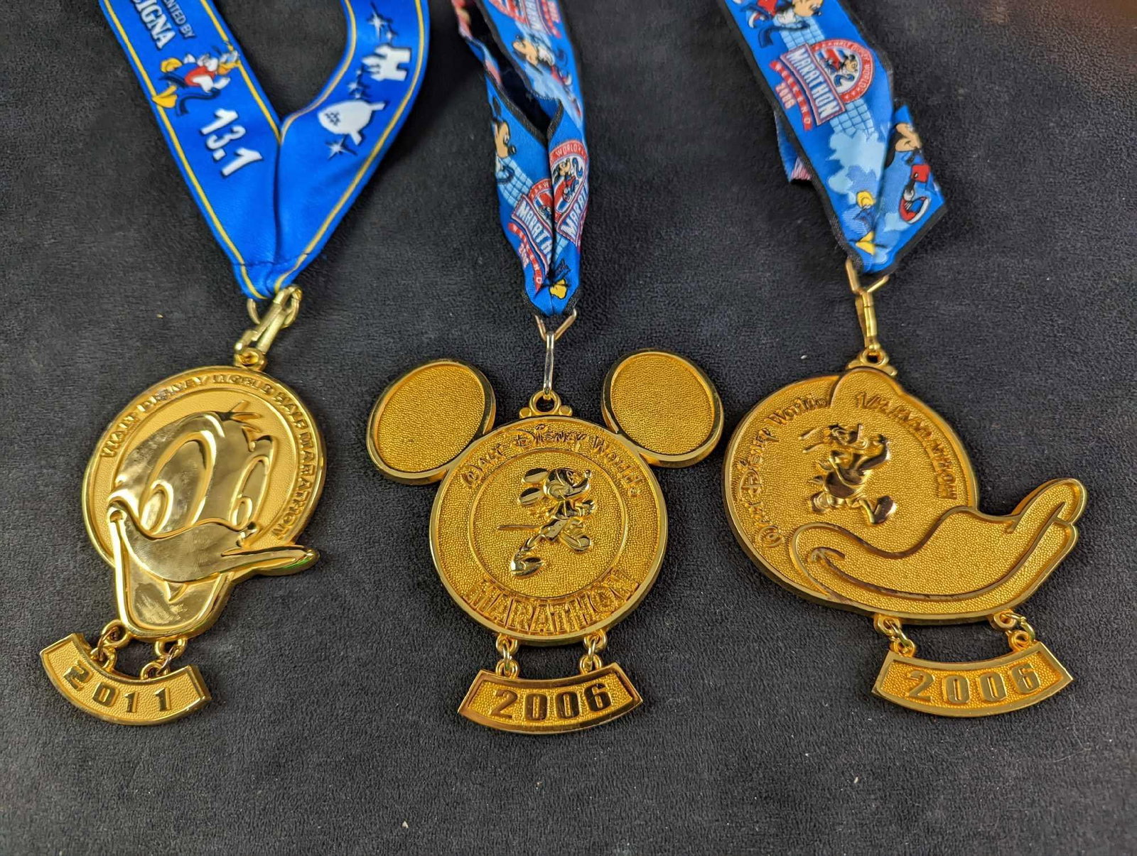 JB Three Mickey & Donald Disney Race Medals: This lot includes: (1) 2006 Walt Disney World Marathon Weekend Medal With Mickey Mouse. This is approx 4" x 22". (1) 2006 Walt Disney World Marathon Weekend Medal With Donald Duck. This is app