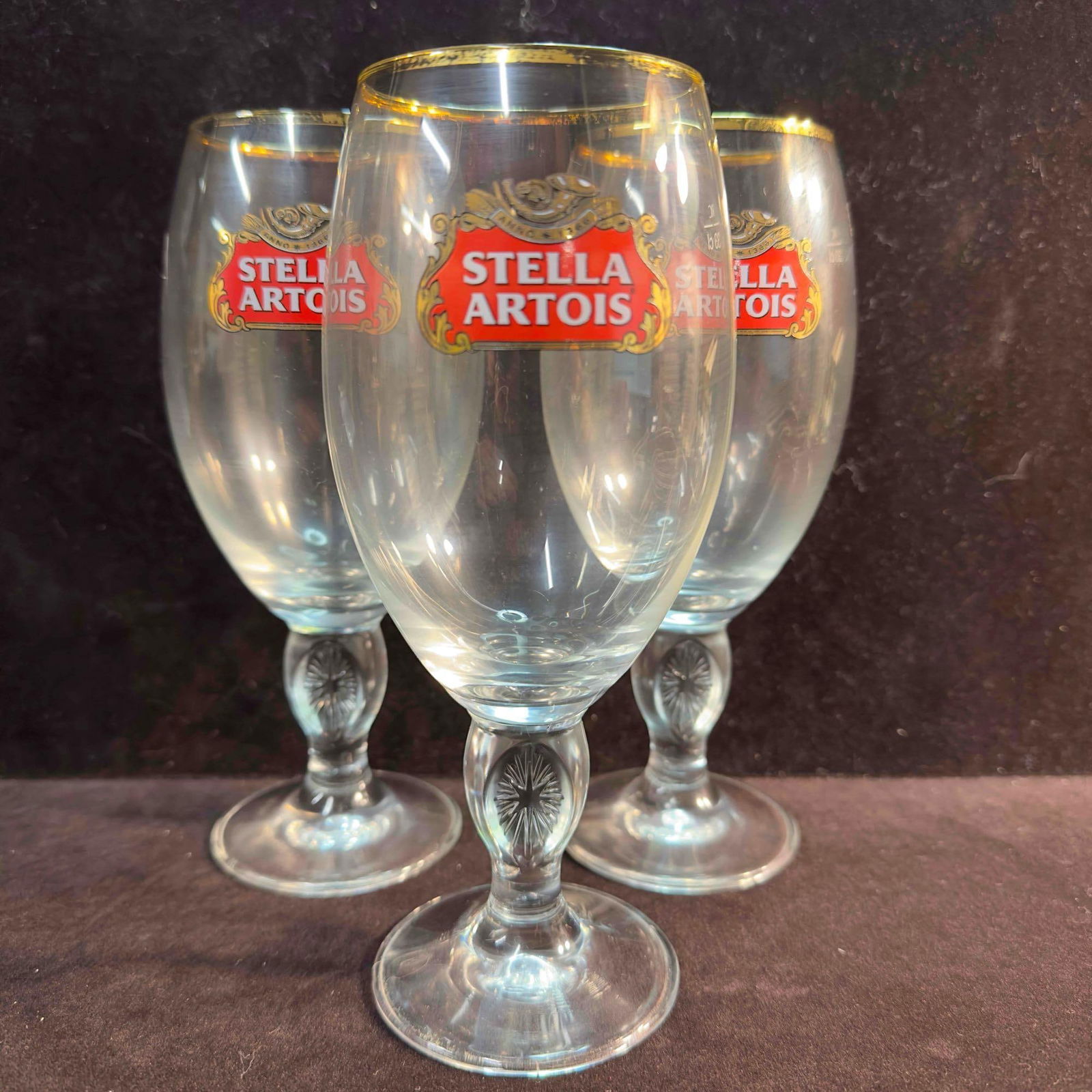 Stella Artois Beer Glass Chalice Star Three 3 Glasses: Stella Artois Beer Chalice Star set of Three (3) Glasses 33cL. The glasses have the clear Stella Artois logo on the side with a gold rim on the top. The item is in great pre-owned, previously displaye