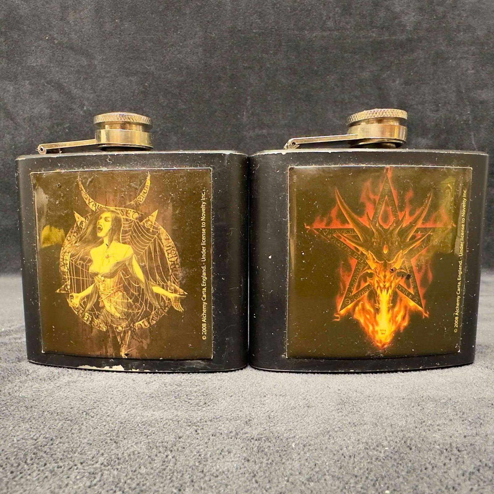 Alchemy Carta England 2008 Novelty Co Demon Vampire Flask Set: Alchemy Carta England 2008 Novelty Co Demon Vampire Flask Set.. Two flasks from Alechemy Carta Novelty Co representing a demon and a vampire both black in color. These items are in good pre-owned, pre