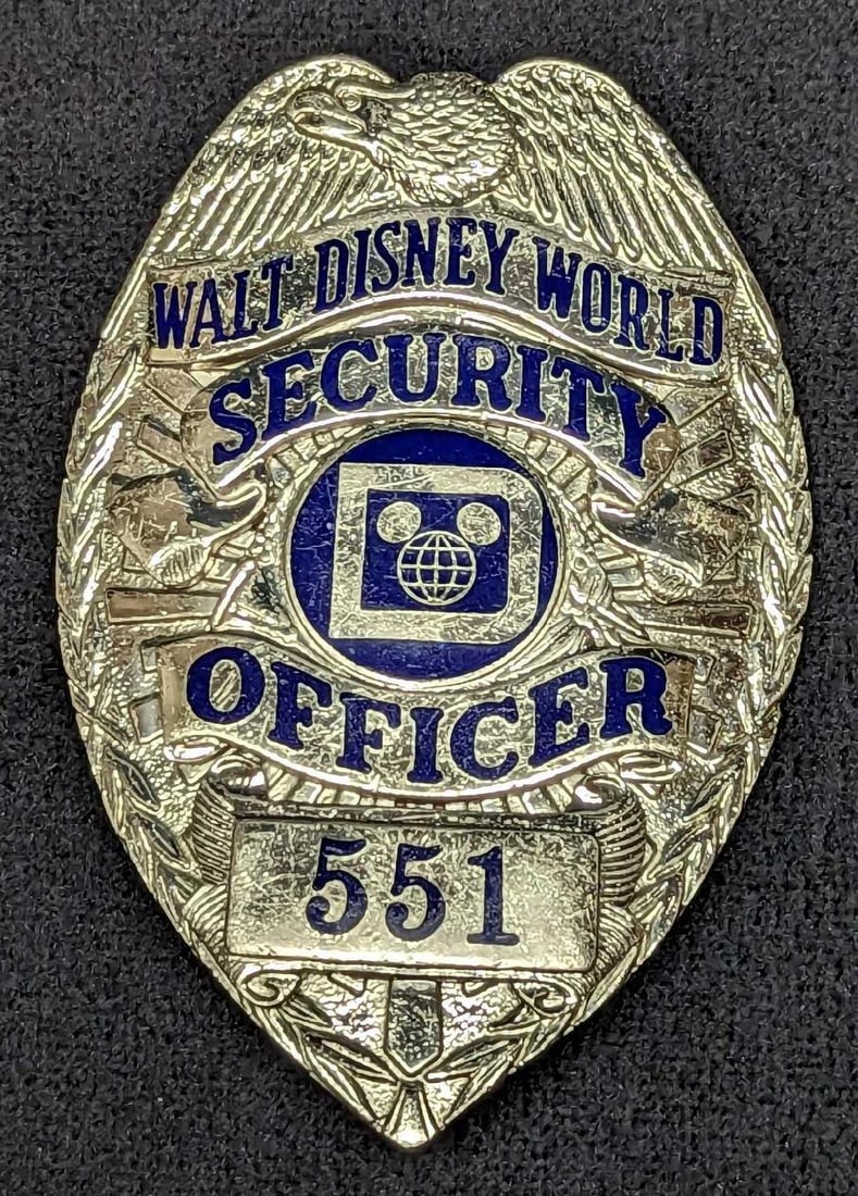 Early 1980s Disney World Security Badge 551: Early 1980s Disney World Security Badge 551. Is approx 2 1/4" x 3/4" x 3 1/4" and it weighs under one pound at 0.16lb. The metal badge is in a good, vintage condition with light scratches. Please see 