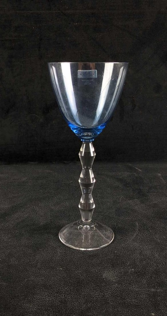 Lenox Gem Blue Glass: Lenox Gem Blue Glass This glass is color gem blue and it has a stylized stem. There is slight wear on the bottom of the glass and a few scratches. This is a lovely blue color that isn't too dark. 