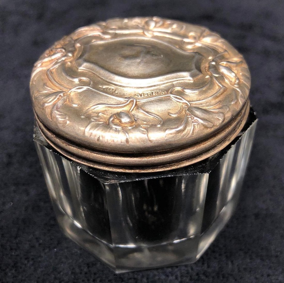 Vintage Powder Jar - Cut Glass Sterling Silver Lid: This lot contains Vintage Cosmetic Powder Jar - Cut Glass with Repousse Sterling Silver Lid. It is approx 2-1/2" x 2-1/2" x 1-3/4" and weighs about 0.2lbs. Overall the Cosmetic Jar is in good used con