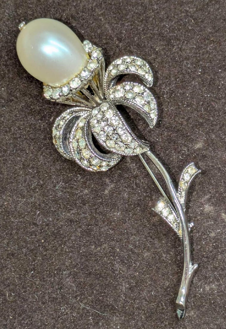 Vintage Silver Tone Rhinerone Faux Baroque Pearl Flower Brooch: Vintage Silver Tone Rhinerone Faux Baroque Pearl Flower Brooch. Is marked "Coro" on the back. Is missing a rhinestone and has some glue residue on the faux pearl. 