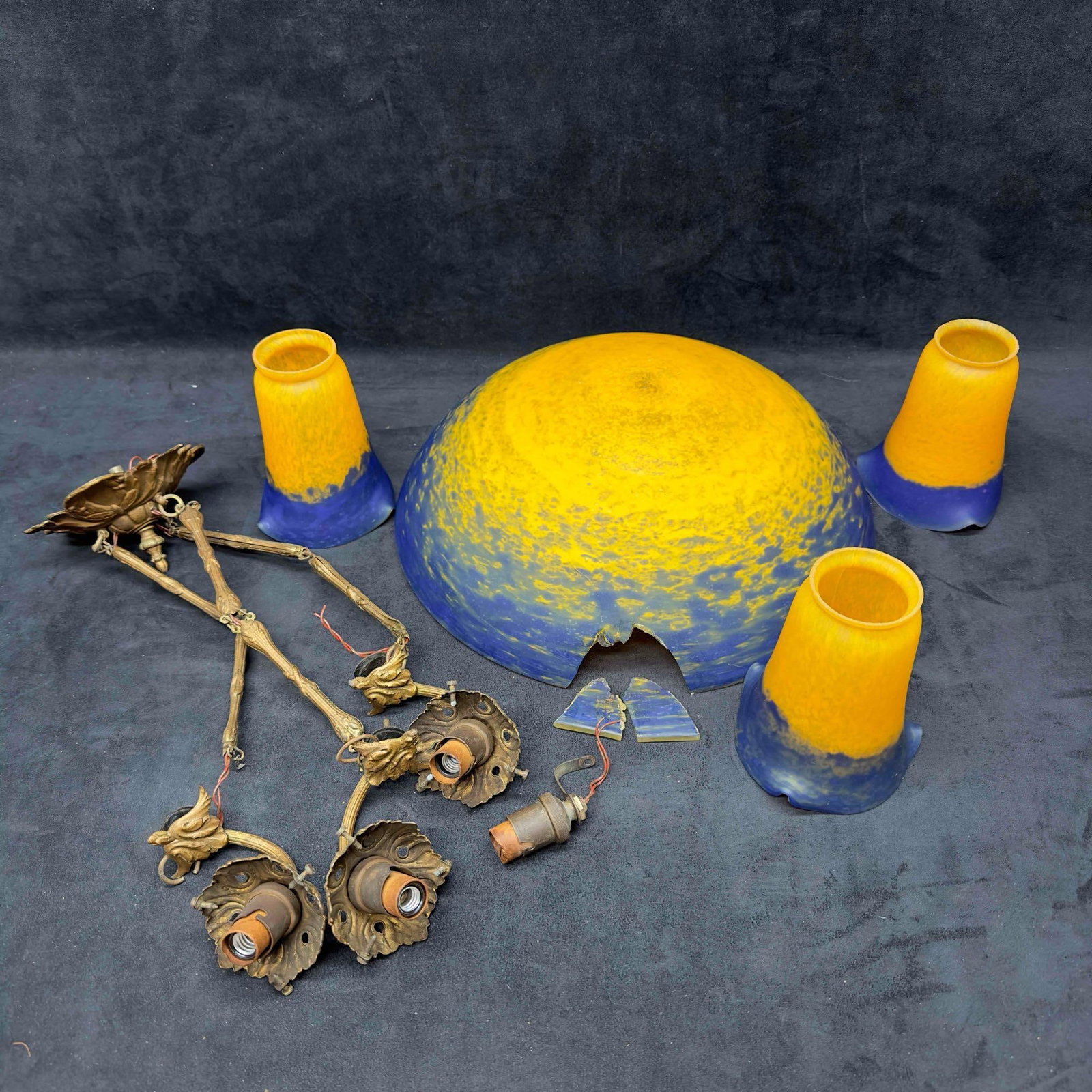 Brass Chandelier Blue and Yellow Glass Light Fixture Broken: Brass Chandelier Blue and Yellow Glass Light Fixture Broken. This vintage chandelier is made of brass and glass. The glass light fixtures are a beautiful deep blue and yellow. The large bowl glass pie