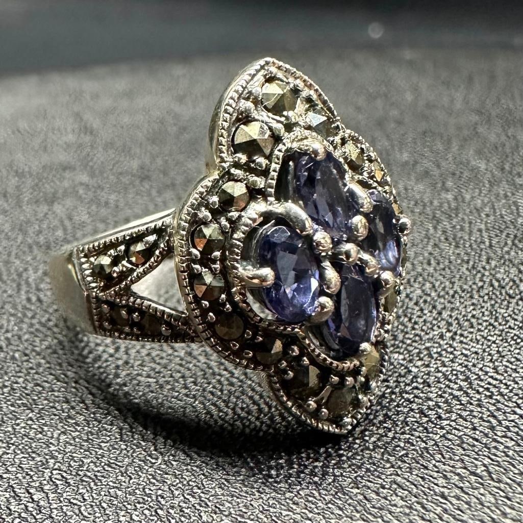 Sterling Tanzanite & Marcasite Ring: This piece of jewelry has been tested and researched prior to listing. Please view all our pictures they are part of our description. DETAILS: Metal - Sterling Silver Color - Silver Stones - Tanzanite
