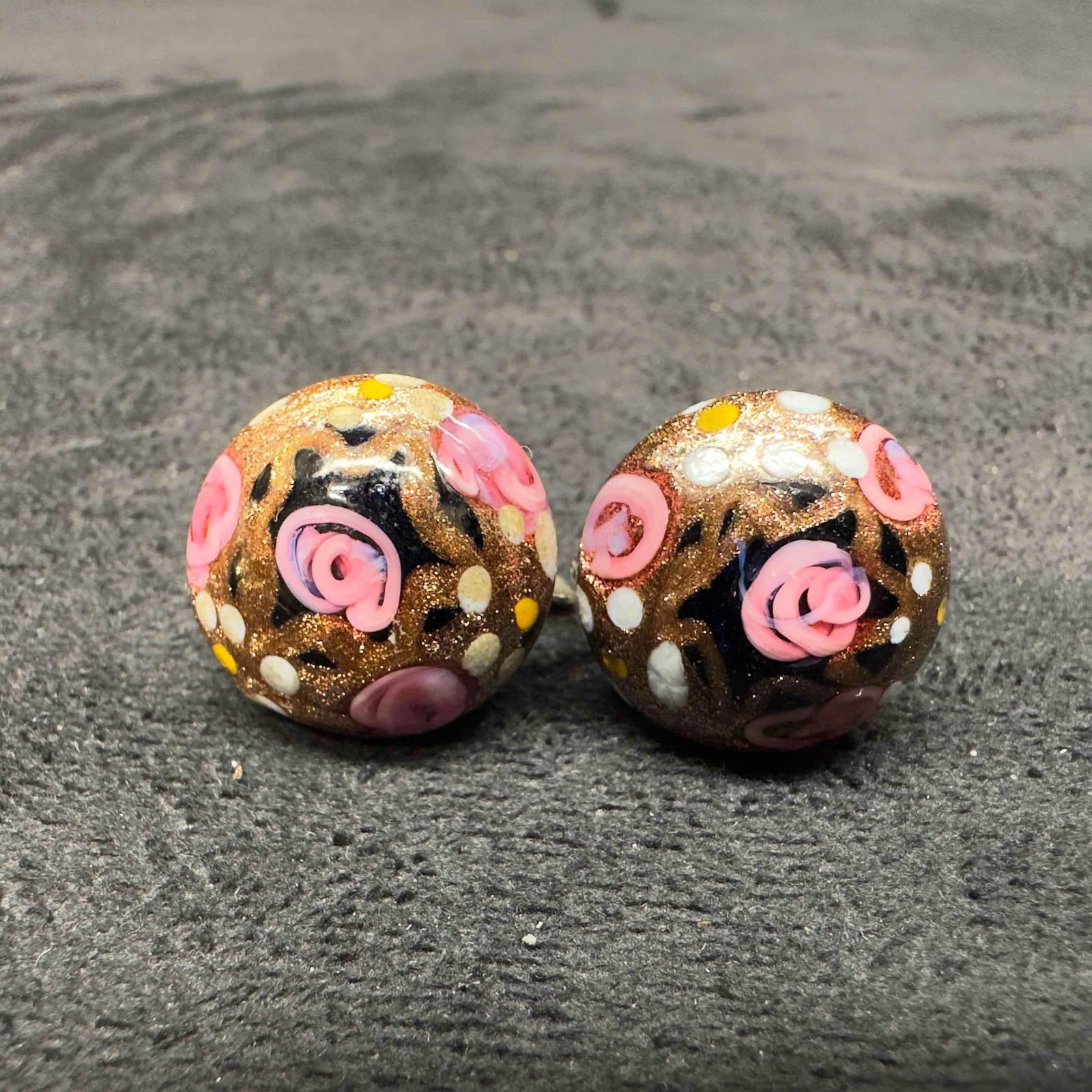 Murano Venetian Art Glass Lamp Work Round Black Bead Floral Earrings D62: Murano Venetian Art Glass Lamp Work Round Black Bead Floral Earrings D62. Earrings with black glass beads with beautiful designs on each. The earrings feature copper colored and floral accents. The ea