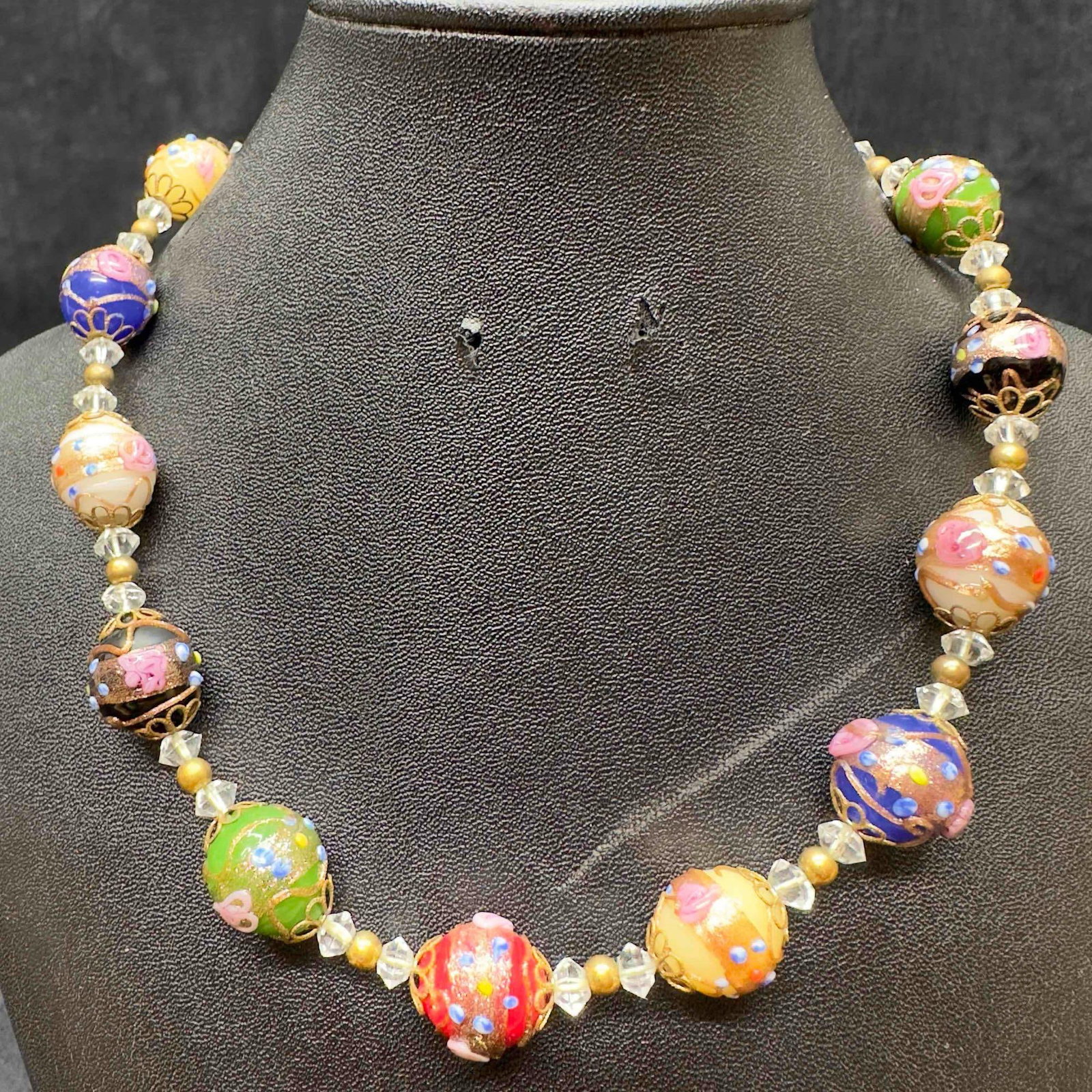 Murano Venetian Art Glass Lamp Work Multi Color Bead Clear Beaded Necklace D77: Murano Venetian Art Glass Lamp Work Multi Color Bead Clear Beaded Necklace D77. Necklace with multi colored glass beads with beautiful designs on each. The necklace features clear bead and floral acce