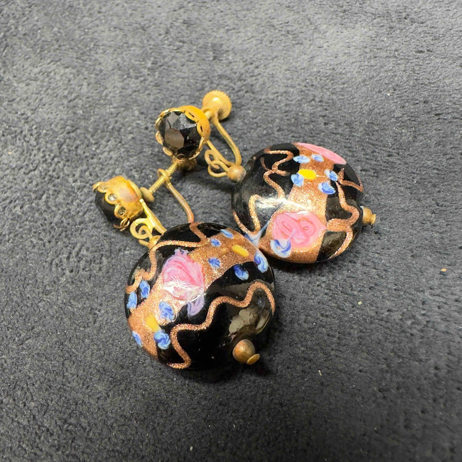 Murano Venetian Art Glass Lamp Work Circle Bead Black Copper Accent Earrings D68: Murano Venetian Art Glass Lamp Work Circle Bead Black Copper Accent Earrings D68. Earrings with black glass beads with beautiful designs on each. The earrings feature copper colored and floral accents