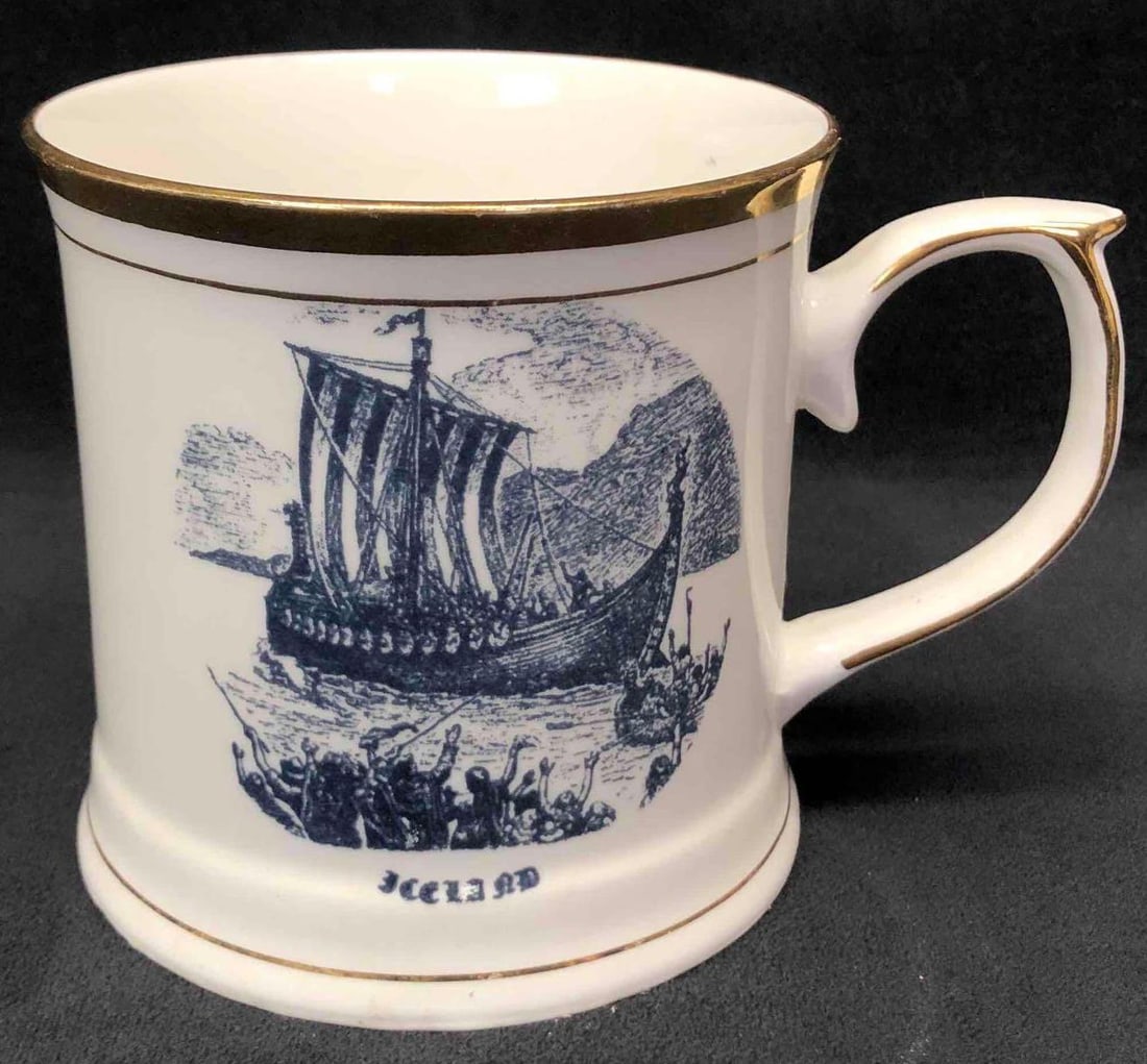 The Viking Ship Fine Bone China Mug By Ramma Gerdin(The Viking Wool Stores): This lot contains "The Viking Ship" fine bone China mug by Ramma Gerdin the Viking Wool Stores. Made in England. The mug is hand painted and embossed with gold for aesthetic purposes. It is approx 4 3