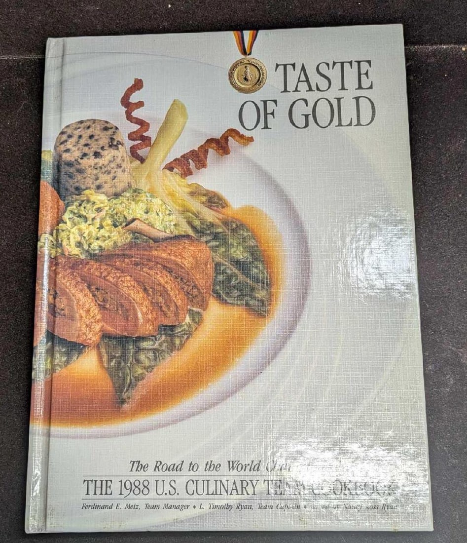 Autographed Taste Of Gold Culinary Team Cookbook: "Taste Of Gold: The Road To The World Championship". The 1988 US Culinary Team Cookbook. The book appears to be autographed by some of those who worked on the book and some of the US Culinary team as 