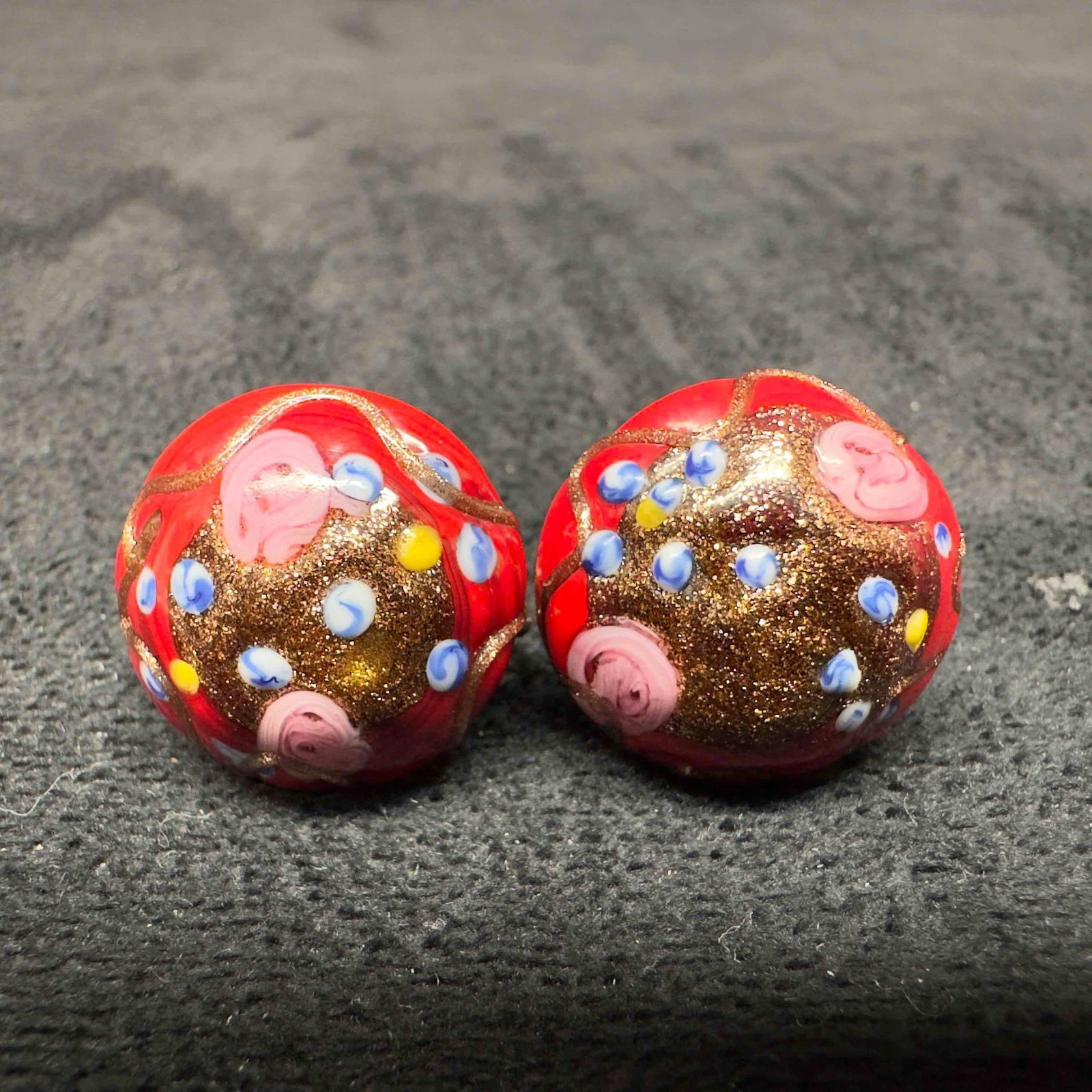 Murano Venetian Lamp Work Art Glass Red Floral Accents Circle Earrings E31: Murano Venetian Lamp Work Art Glass Red Floral Accents Circle Earrings E31. Earrings with red colored glass beads with beautiful hand painted designs on each. The earrings feature pink and copper colo