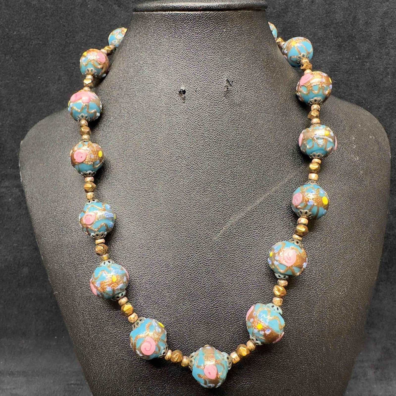 Venetian Murano Art Glass Lamp Work Blue Floral Bead Pink Fiorato Beaded Necklace E23: Venetian Murano Art Glass Lamp Work Blue Floral Bead Pink Fiorato Beaded Necklace E23. Necklace with blue colored glass beads with beautiful hand painted designs on each. The necklace features pink co