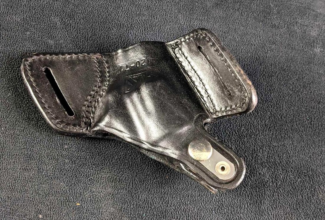 Black Leather Holster Revolver Holster Triple K: Black Leather Holster Revolver Holster This is a black holster for a 38 revolver. This is in good condition with only a few scratches and a revolver imprint. This is a genuine leather holster made by 