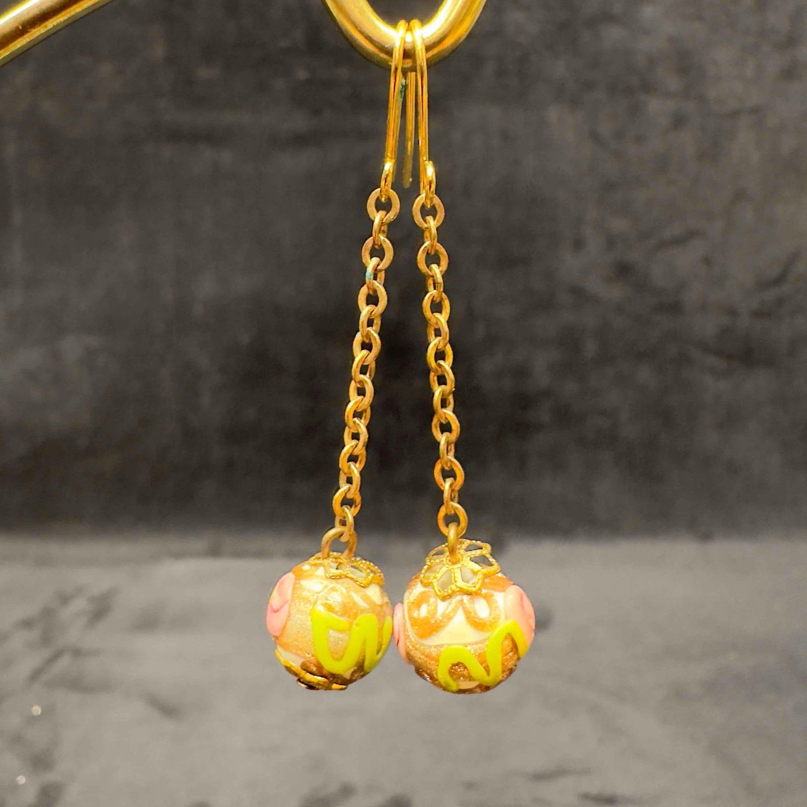 Murano Venetian Art Glass Lamp Work White Floral Accents Dangle Earrings E19: Murano Venetian Art Glass Lamp Work White Floral Accents Dangle Earrings E19. Earrings with white colored glass beads with beautiful hand painted designs on each. The earrings feature pink and green c