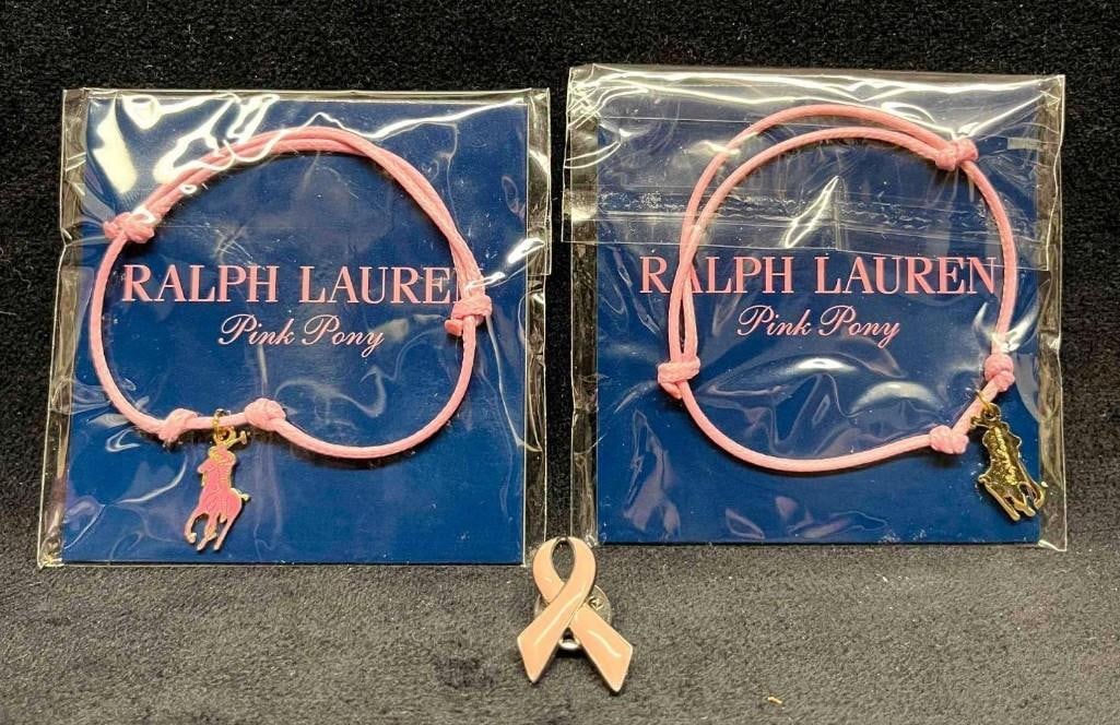Two Unopened Ralph Lauren Pink Pony Bracelets & Breast Cancer Ribbon Pin: Two Unopened Ralph Lauren Pink Pony Bracelets & Breast Cancer Ribbon Pin. This lot contains Two Unopened Ralph Lauren Pink Pony Bracelets & Breast Cancer Ribbon Pin. The bracelets are adjustable 