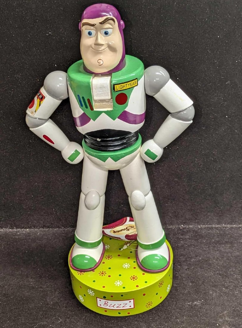 Disney Pixar Decorative Toy Story Buzz Lightyear Nutcracker: Disney Pixar Decorative Toy Story Buzz Lightyear Nutcracker. This is approx 7" x 5" x 13 1/4" and it weighs 1.98lb. There are some markings on the nutcracker and the left arm is missing a decal. 
