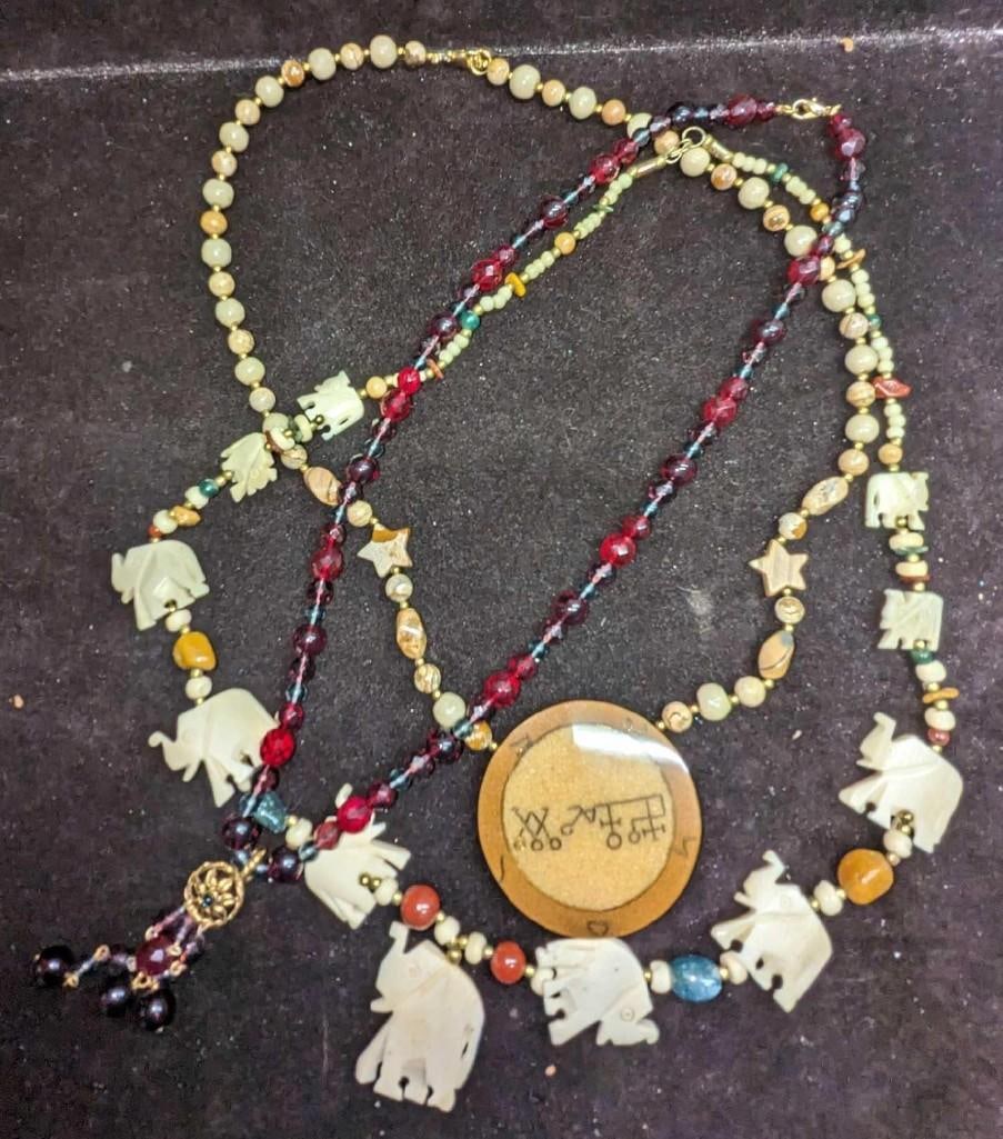 3 Camel Bone Lee Sands Jasper Burgundy Beaded Necklaces: 3 Camel Bone Lee Sands Jasper Burgundy Beaded Necklaces. This lot includes: (1) Camel Bone Elephant Beaded Necklace. This measures 29". (1) Lee Sands Jasper Necklace With Medallion Pendant. This m