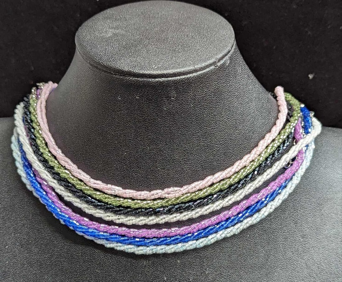 7 Nolan Miller Couture Color Bugle Bead Necklaces: 7 Nolan Miller Couture Color Bugle Bead Necklaces. Here is a collection of colorful necklaces by Nolan Miller. Necklaces are approx 18". All come in a bag that is approx 4" x 1" x 4" and it weigh