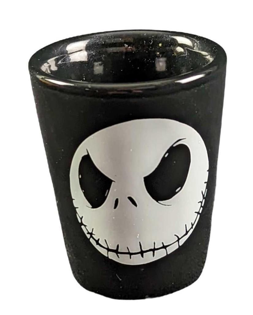 Disney Nightmare Before Christmas Jack Skellington Shot Glass: Disney Nightmare Before Christmas Jack Skellington Shot Glass. Made of ceramic. Is approx 2" x 2" x 2 1/4" and it weighs 0.20lb. The shot glass is in a good, unused condition with no chips or cracks. 