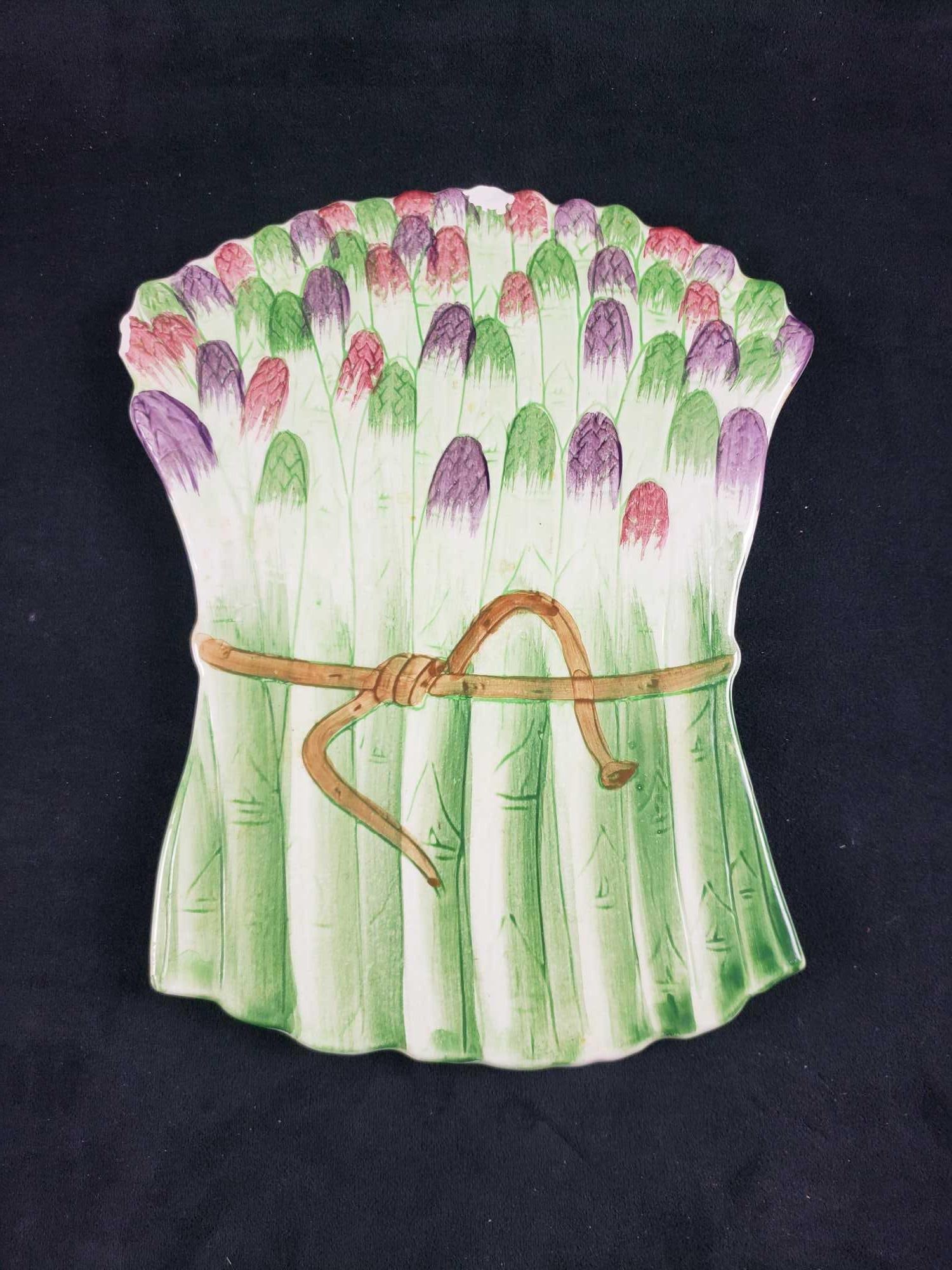 Italian Ceramic Asparagus Trivet: Italian Ceramic Asparagus Trivet. This ceramic tile is in fair condition. There is a small chip at the top of the tile. The tile is marked as made in Italy on the back with the number 7471. The trivet