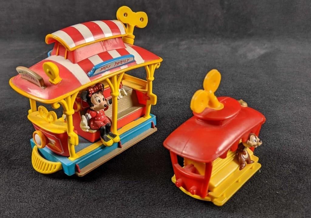 Disneyland Towntown Trolley Set Of Two Mickey Mouse Pull Back Toy: Disneyland Towntown Trolley Set Of Two Mickey Mouse Pull Back Toy. This set includes one trolley with Mickey and Minnie Mouse that is a pull-back and release moving toy that works. And one mini w