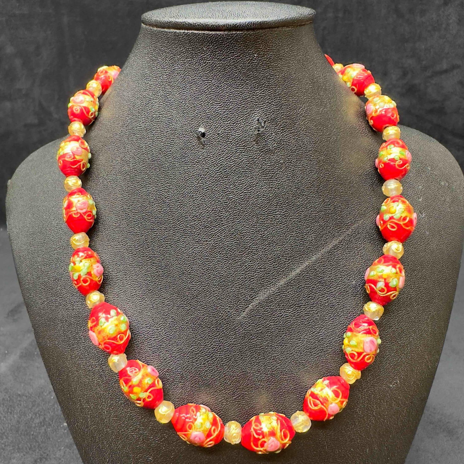 Venetian Murano Lamp Work Art Glass Red Bead Floral Beaded Accent Necklace D29: Venetian Murano Lamp Work Art Glass Red Bead Floral Beaded Accent Necklace D29. Necklace with red colored glass beads with beautiful designs on each. The necklace features floral accents. The necklace
