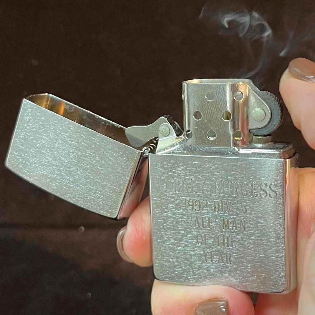 Vintage Bradford Zippo Lighter K VII PA Engraved To Audrey Burgess Salesman Of The Year 1992: This lot contains a Vintage Bradford Zippo Lighter K VII PA Engraved To Audrey Burgess Salesman Of The Year 1992. It is approx 1 1/2" x 1/2" x 2 1/4" and it weighs about 0.1lbs. Overall the Zippo
