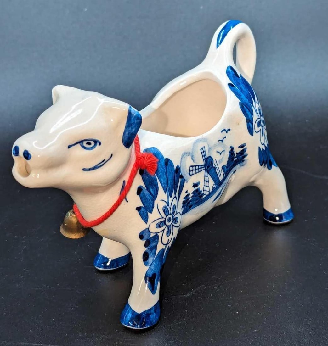 Vintage Delft blue Holland Ceramic Cow Creamer: Vintage Delft blue Holland Ceramic Cow Creamer. This is approx 4 1/2" x 2 3/4" x 3 1/4" and it weighs 0.31lb. The creamer has some crazing and has some markings on the outside and inside.