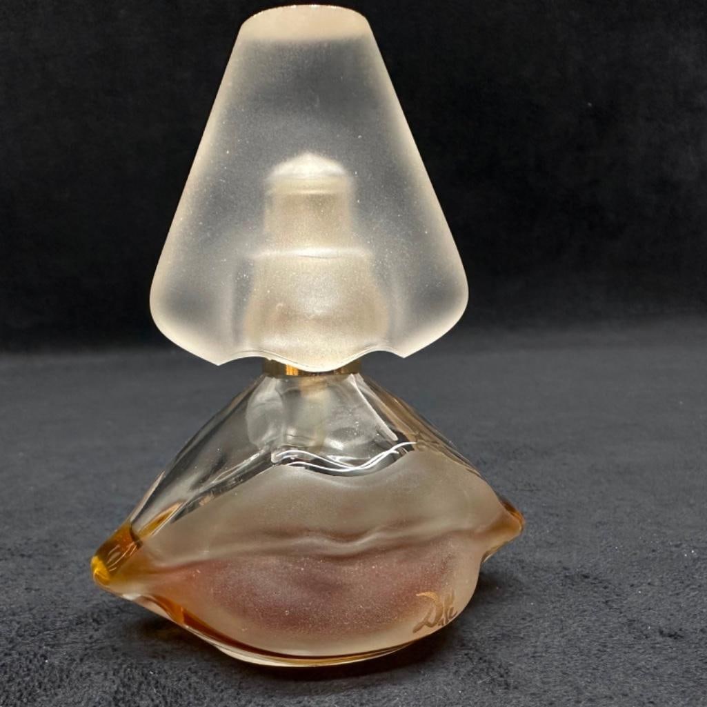 Vintage Salvador Dali Perfume Bottle: Vintage Salvador Dali Perfume Bottle Dali perfume bottle in frosted clear glass with some perfume left in the bottle. Is stamped "S Dali Ray Int. Paris" on the bottom. In good condition with n