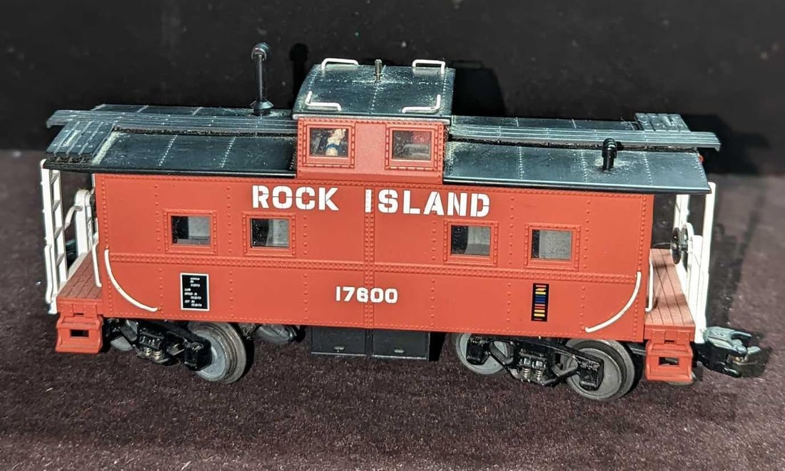 MTH Rock Island 17600 Red Caboose: MTH Rock Island 17600 Red Caboose. Comes in its original package that is approx 11 1/2" x 3 3/4" x 6 1/8" and it weighs 1.15lb. The caboose has some markings and light wear. Please see the images as t