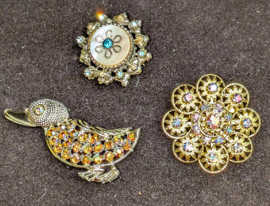 3 Vintage Coro AB Crystals Gold Tone Pin Brooches: 3 Vintage Coro AB Crystals Gold Tone Pin Brooches. This lot includes: (1) Coro Gold Tone Mother Of Pearl And Rhinestone Brooch. This is approx 1 1/4" x 1 1/4" x 1/2". (1) Aurora Borealis