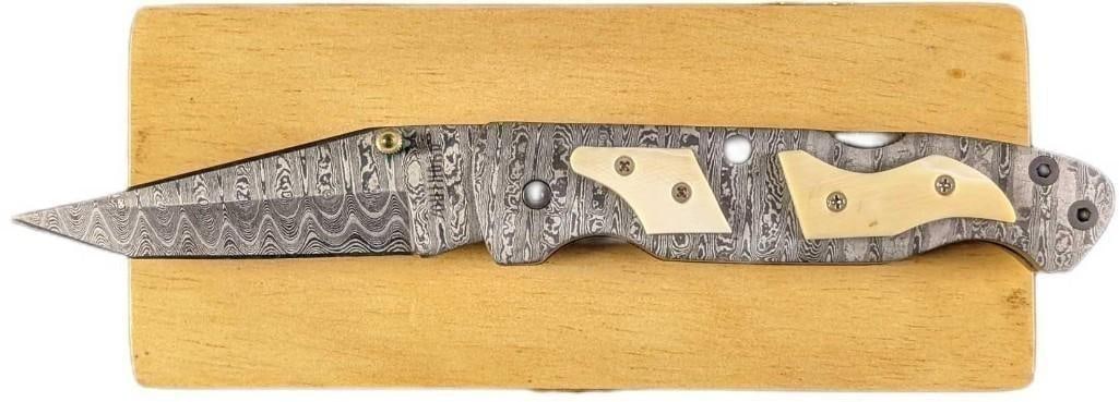 Damascus Steel Fold Up White Bone Handle Knife Retired: Damascus Steel Fold Up White Bone Handle Knife Retired. Here is a fold-up knife made of imported Damascus steel with a white natural bone handle. These were made in very limited batches by a small com