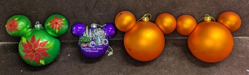 4 Mickey Mouse Colorful Glass Ball Ornaments: 4 Mickey Mouse Colorful Glass Ball Ornaments.This lot includes: (2) Orange Ornament. This is approx 6" x 4" x 6". One of the ornaments has a cracks. (1) Green & Red Ornament. This is