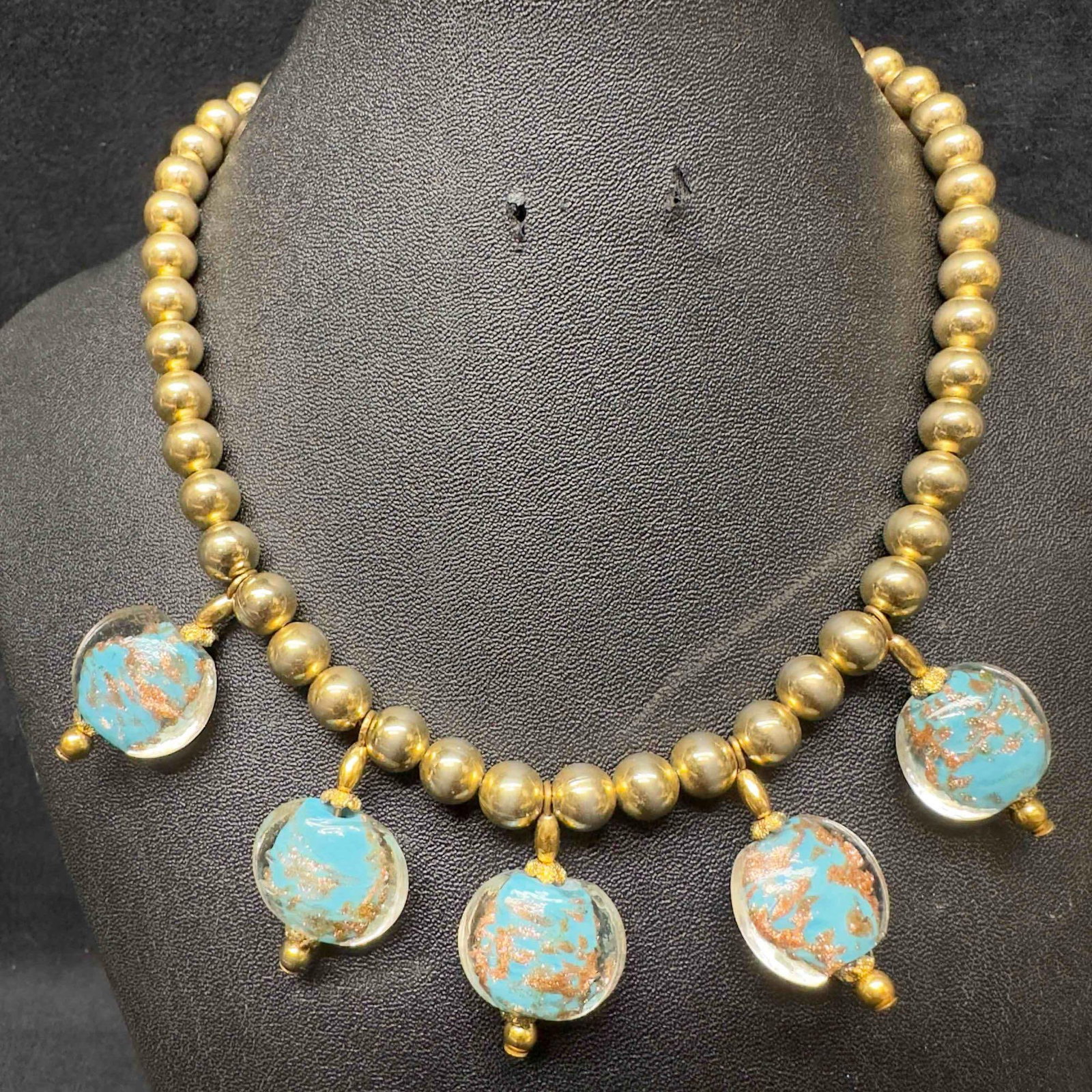 Venetian Murano Art Glass Lamp Work Aqua Blue Beaded Copper Accent Gold Toned Necklace C93: Venetian Murano Art Glass Lamp Work Aqua Blue Beaded Copper Accent Gold Toned Necklace C93. Necklace with aqua blue colored glass beads with beautiful designs on each. The necklace features gold toned