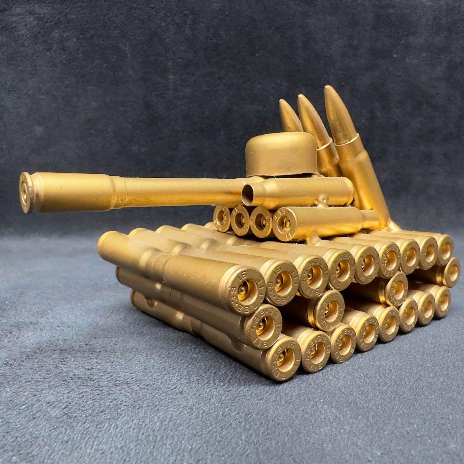 Treasure Gurus Bullet Shell Casing Shaped Army Tank Metal Sculpture: Treasure Gurus Bullet Shell Casing Shaped Army Tank Metal Sculpture. A military army tank shaped entirely out of bullet shell casings. Each gun shell casing has a brass painted finish on it. This item