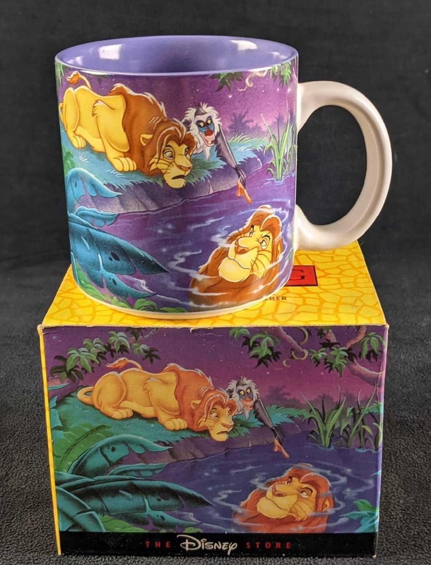 Disney's The Lion King Ceramic Mug With Box: Here is a mug originally sold at the Disney Store that shows Simba and Rafiki glancing into a pond and seeing Simba's father Mufasa in the reflection. The 12 oz mug is approx 5" x 3 1/4" x 3 1/4". It 