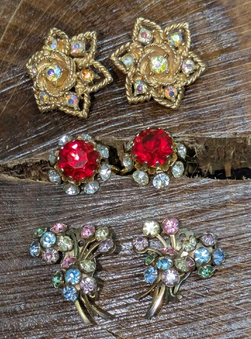 3 Sets Of Vintage Boucher Coro Clip On And Screw Back Earrings: 3 Sets Of Vintage Boucher Coro Clip On And Screw Back Earrings. This lot includes: (1) Set Of Coro Red And Clear Rhinestones Gold Tone Screw Back Earrings. Each is approx 5/8" x 7/8" x 5/8