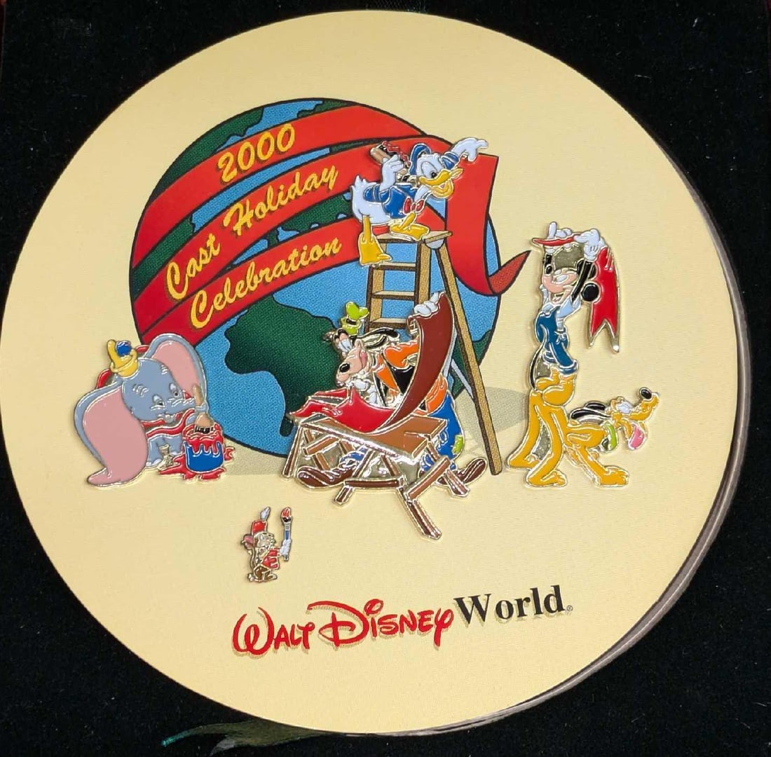 Disney World Cast Holiday 2000 Celebration Pin Set: Disney World Cast Holiday 2000 Celebration Pin Set. Comes with five different pins in a wooden box. Was originally only given to Walt Disney World employees. Comes in its original cardboard box which 