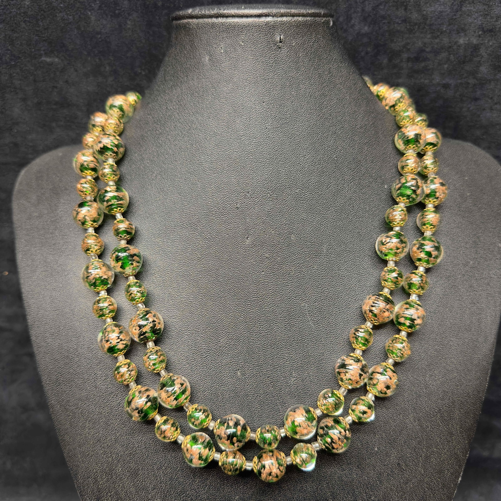 Venetian Murano Lamp Work Glass Green Round Bead Long Beaded Necklace A6: Venetian Murano Lamp Work Glass Green Round Bead Long Beaded Necklace A6. Necklace with green colored round shaped glass beads with a beautiful design. The necklace features a barrel clasp. This item 