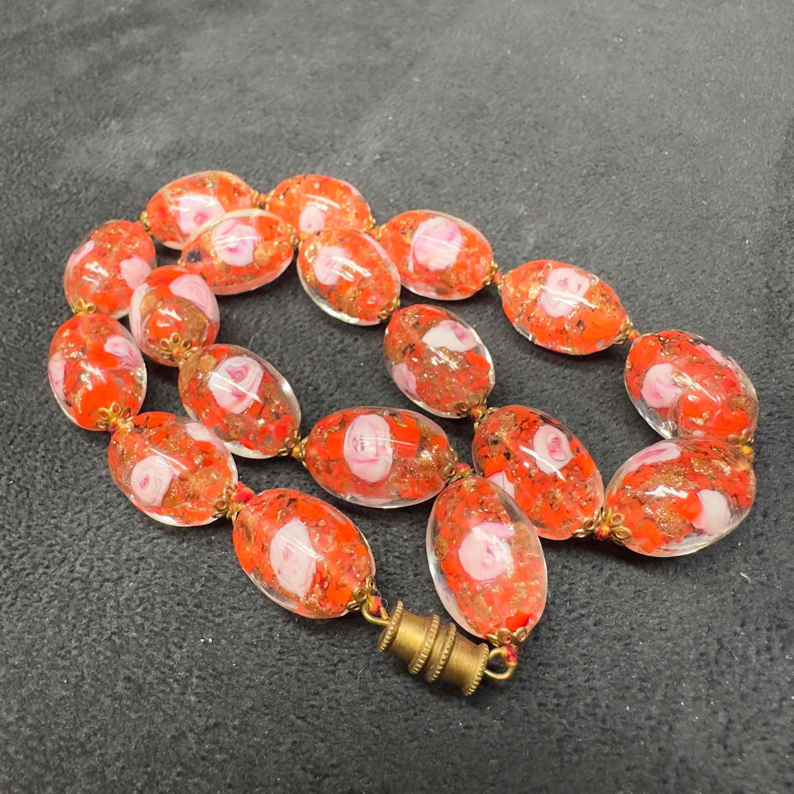 Murano Venetian Lamp Work Glass Red Bead Pink Flower Beaded Necklace A78: Murano Venetian Lamp Work Glass Red Bead Pink Flower Beaded Necklace A78. Necklace with red colored glass beads with beautiful designs on each. The necklace features pink colored flower accents. The n