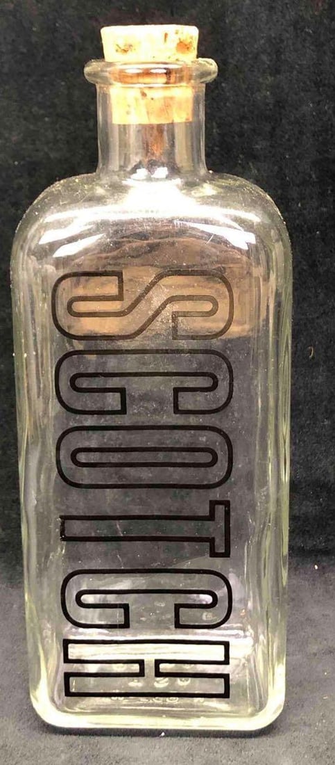 TCW Co. Glass Scotch Bottle: This lot contains a TCW Co. glass scotch bottle. This bottle is the perfect addition to any bar or man cave. Made in the U.S.A. It is approx 3 3/4" x 2 1/2" 10 1/2" and weighs about 1.5lbs. the bottle