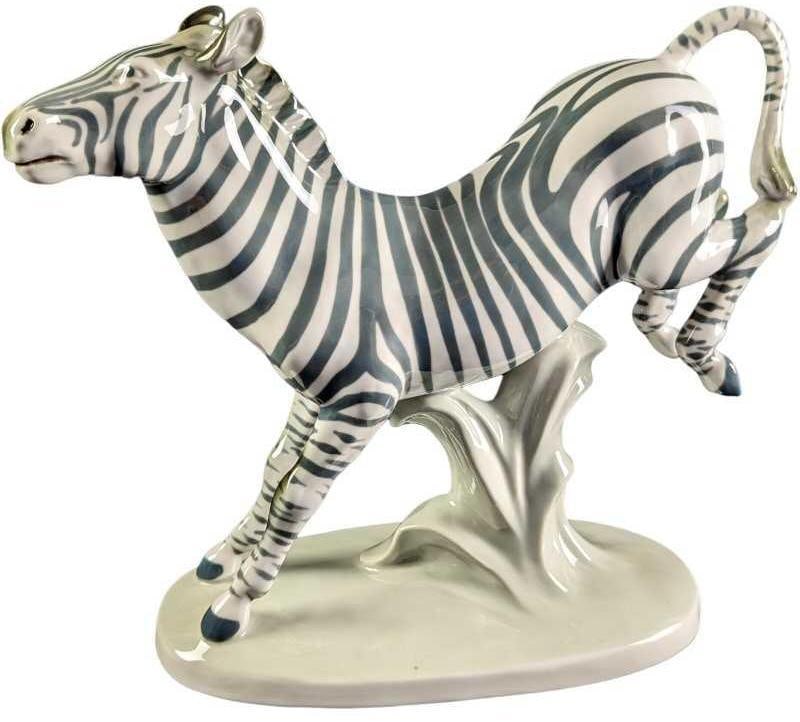 JB Royal Dux Kicking Zebra Porcelain Figurine: Royal Dux "Kicking Zebra" Porcelain Figurine. This figurine is approx 11" x 4 1/2" x 10 1/2" and it weighs 2.92lb. The figurine is in a good, vintage condition with no chips or cracks. There is a litt