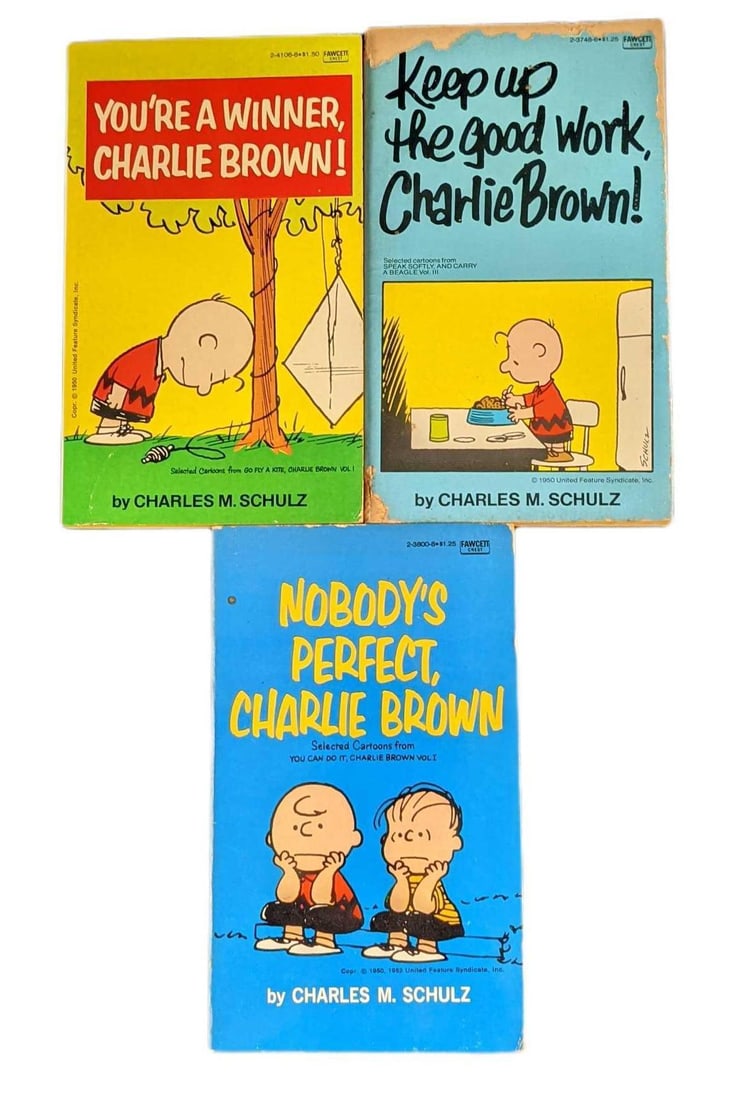 3 Vintage Paperback Charlie Brown Snoopy Books: This lot includes: (1) You're A Winner Charlie Brown! Published by Fawcett (New York) in 1960. (1) Keep Up The Good Work Charlie Brown! Published by Fawcett (New York) in 1975. (1) Nobody's Pe