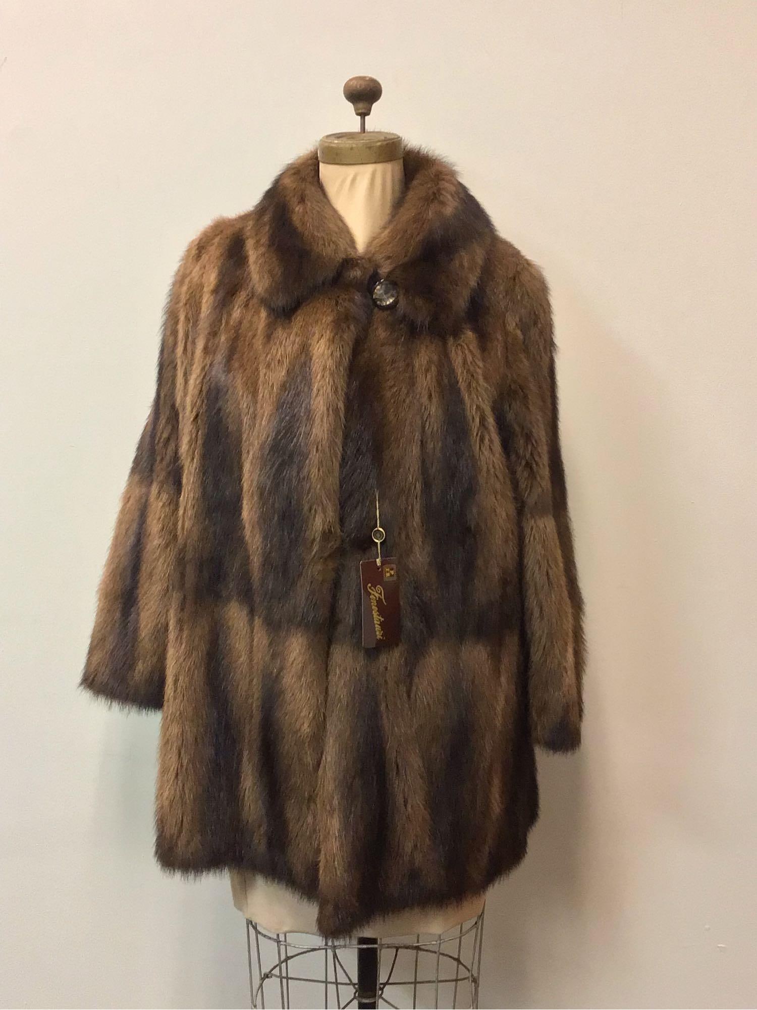 Finestauri Raccoon Fur Coat: Finestauri Raccoon Fur Coat. This coat features one button closure, one hook and clip and brown linen interior with baroque pattern. It is in good condition with no known damages. Approximate measurem