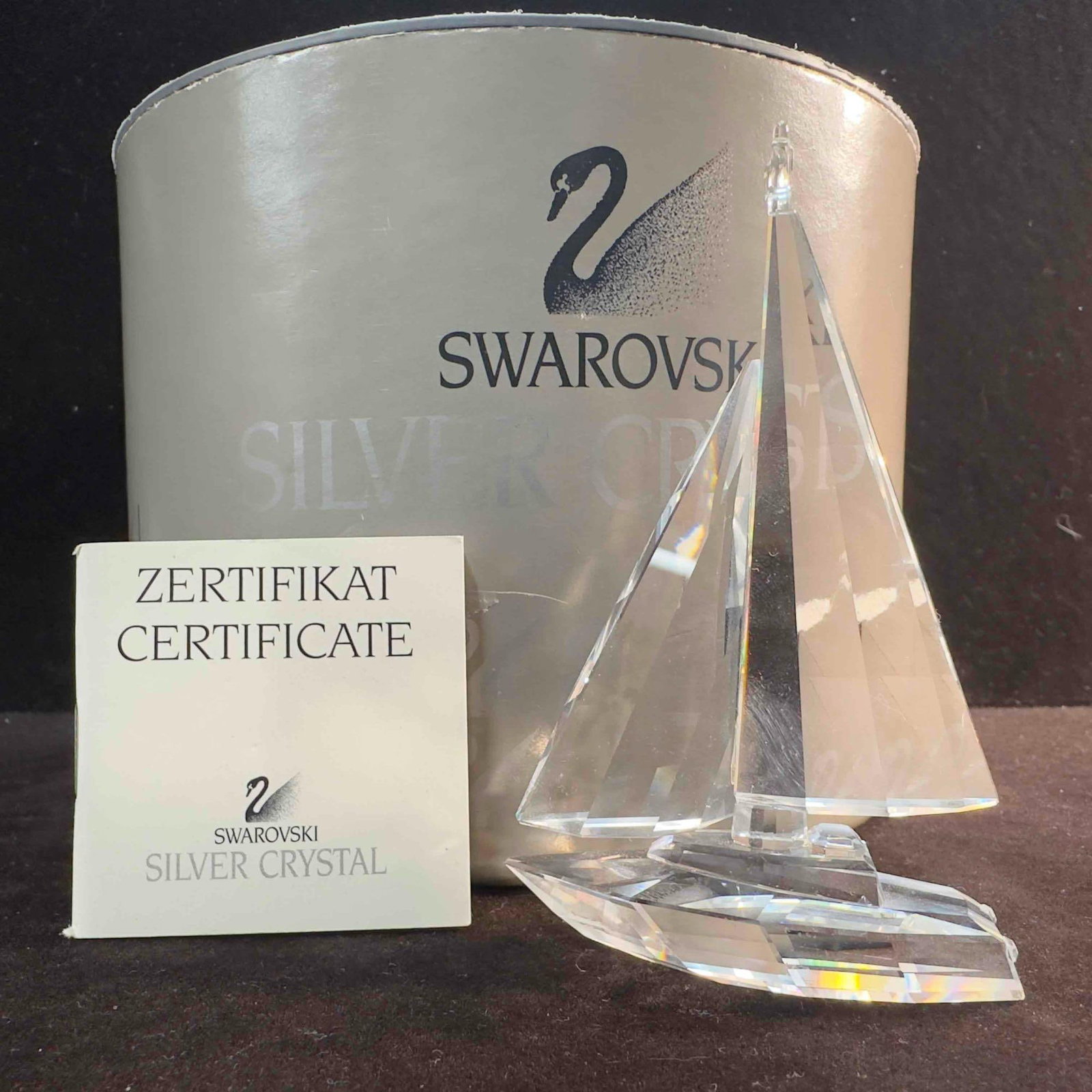 Swarovski Crystal Sailboat Figurine 7473 NR 000 004: Swarovski Clear Crystal Glass Sailboat Figurine. This figure is a beautiful crystal glass art piece featuring a Sailboat from Swarovski Crystal. The item features a beautifully etched art glass piece 