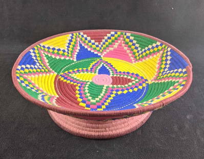 Hand Woven Basket Colorful Ethiopian Basket: Hand Woven Basket Colorful Ethiopian Basket This basket is beautifully woven from Ethiopia. This basket is in good condition with no known damage. There may be some wear from age. 13 1/4in diameter 0