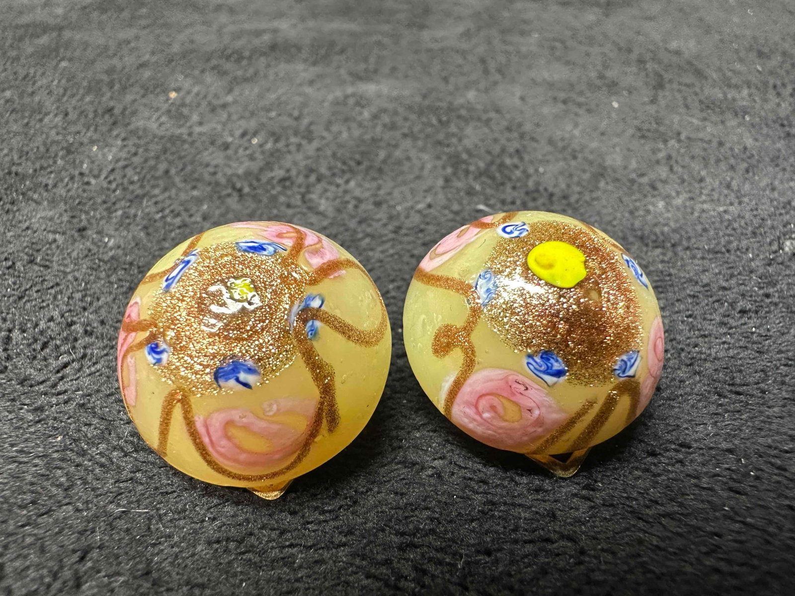 Murano Venetian Art Glass Lamp Work Cream Colored Circle Earrings G76: Murano Venetian Art Glass Lamp Work Cream Colored Circle Earrings G76. Earrings with cream colored glass beads with beautiful designs on each. The earrings feature a paddle back clip on clasp closure.
