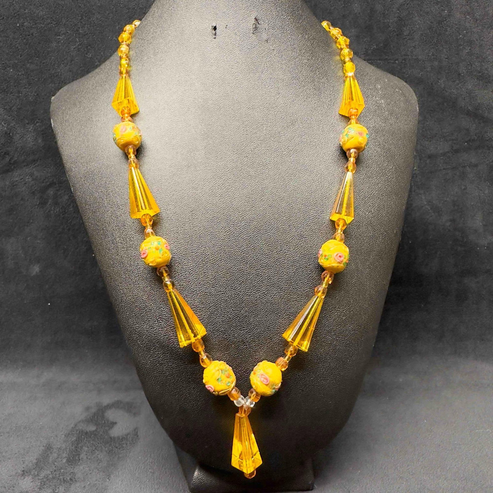 Venetian Murano Lamp Work Art Glass Bead Floral Yellow Beaded Pendant Necklace C45: Venetian Murano Lamp Work Art Glass Bead Floral Yellow Beaded Necklace C45. Necklace with yellow colored glass beads with beautiful designs on each. The necklace features floral accents. The necklace 