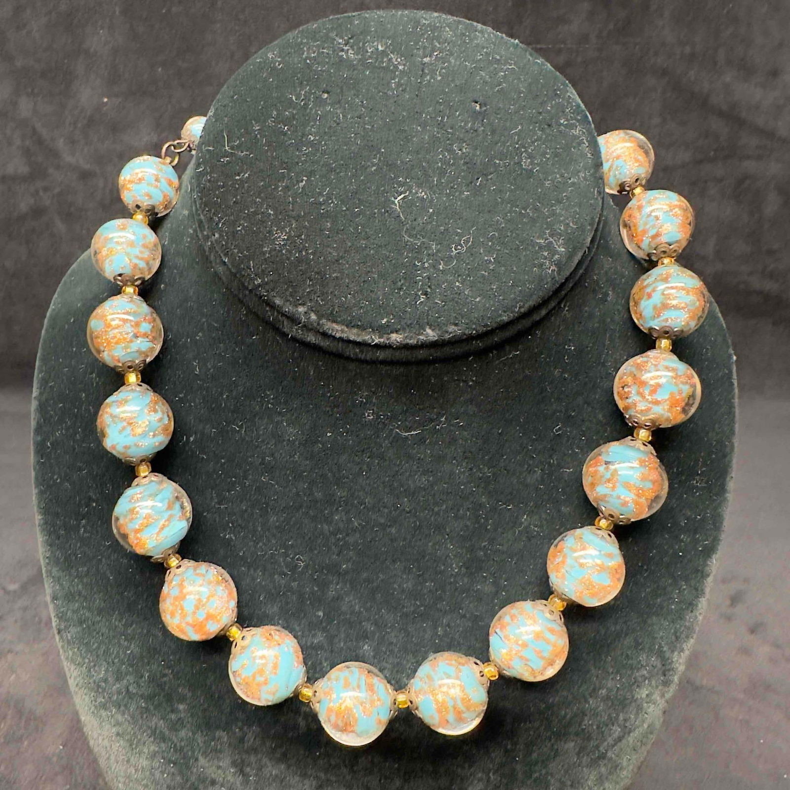 Venetian Murano Lamp Work Art Glass Aqua Colored Copper Infused Round Beaded Necklace C30: Venetian Murano Lamp Work Art Glass Aqua Colored Copper Infused Round Beaded Necklace C30. Necklace with aqua colored glass beads with beautiful designs on each. The necklace features copper infused a