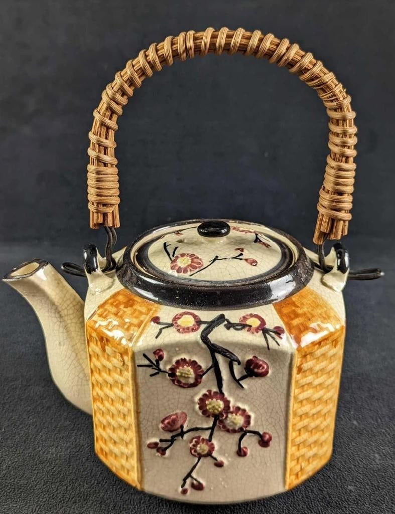 Vintage Japanese Porcelain Crackle Teapot: Vintage Japanese Porcelain Crackle Teapot With Bamboo Handle. The teapot has a company stamp on the bottom. This is approx 7" x 5" x 8 1/2" and it weighs 1.18lb. The teapot is in a good, vintage condi